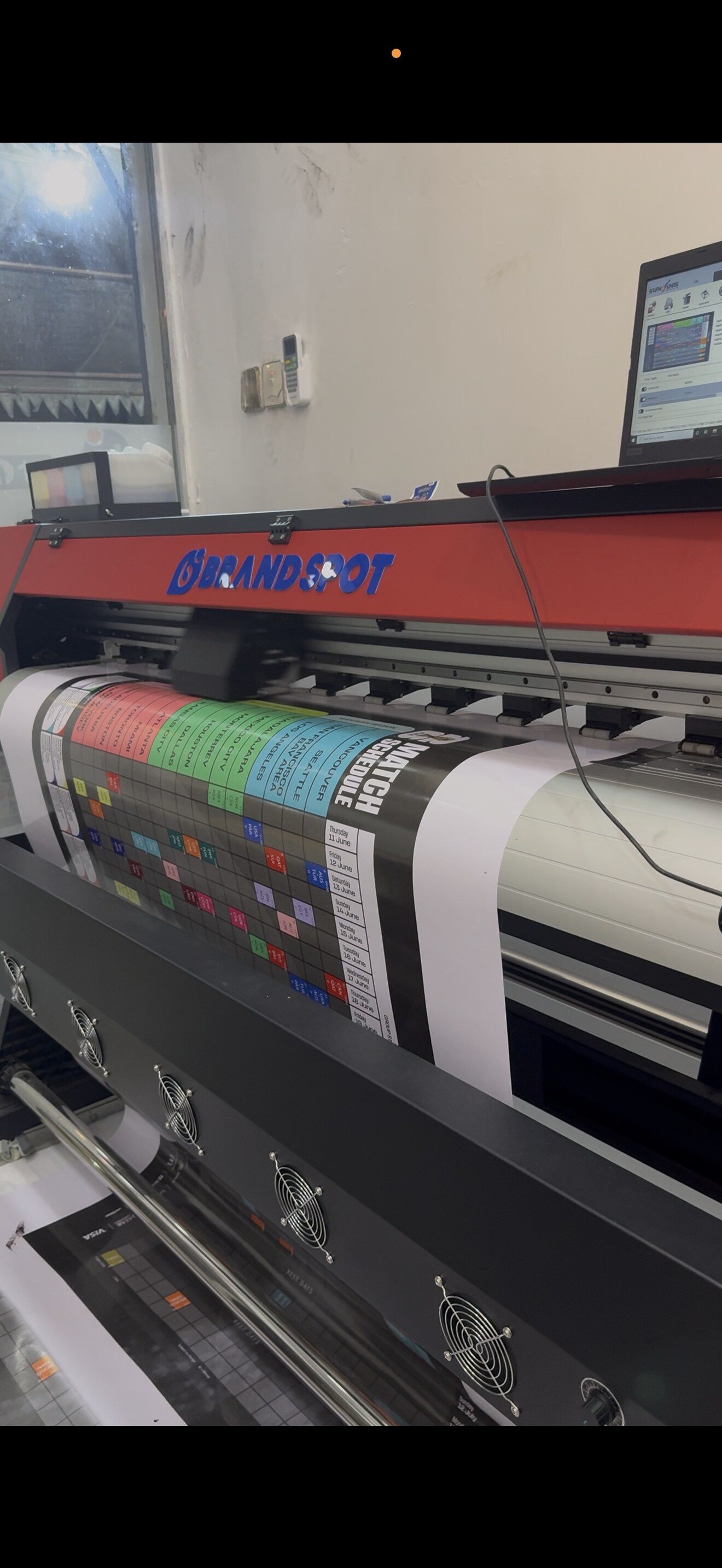 Brandspot large format printer printing a match schedule
